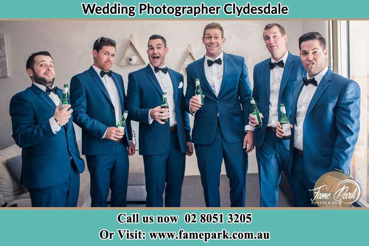 The groom and his groomsmen striking a wacky pose in front of the camera Clydesdale NSW 2330