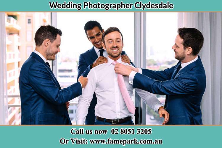 Photo of the Groom helping by the groomsmen getting ready Clydesdale NSW 2330