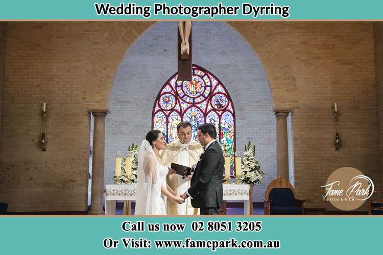 Photo of the Bride and Groom at the Altar with the Priest Dyrring NSW 2330