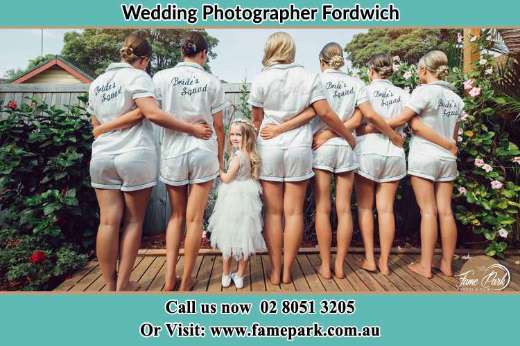 Behind photo of the Bride and the bridesmaids with the flower girl looking back Fordwich NSW 2330