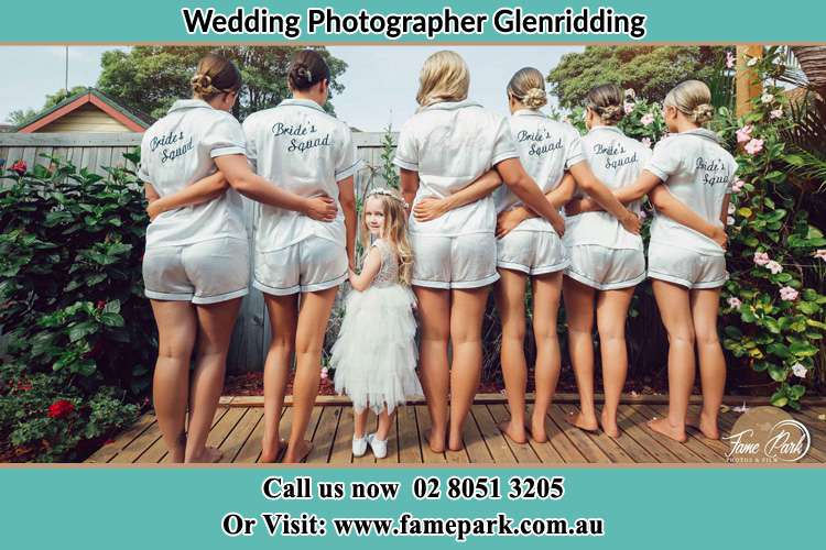 Behind photo of the Bride and the bridesmaids with the flower girl looking back Glenridding NSW 2330