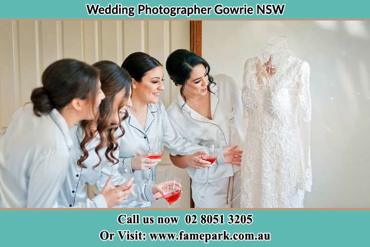 Photo of the Bride and the bridesmaids checking the wedding gown Gowrie NSW 2060