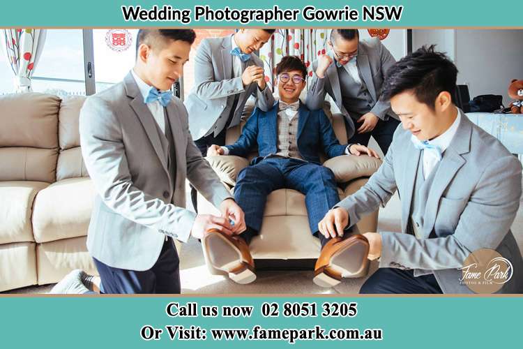 Photo of the Groom helping by the groomsmen getting ready Gowrie NSW 2060