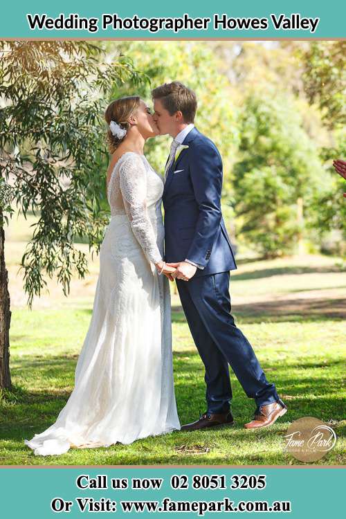 Photo of the Bride and the Groom kissing at the yard Howes Valley NSW 2330