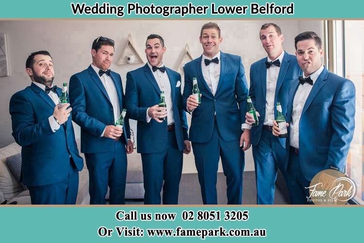 The groom and his groomsmen striking a wacky pose in front of the camera Lower Belford NSW 2335