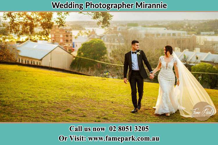 Photo of the Groom and the Bride walking at the yard Mirannie NSW 2330