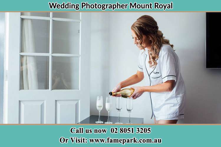 Photo of the Bride pouring wine on the glasses Mount Royal NSW 2330