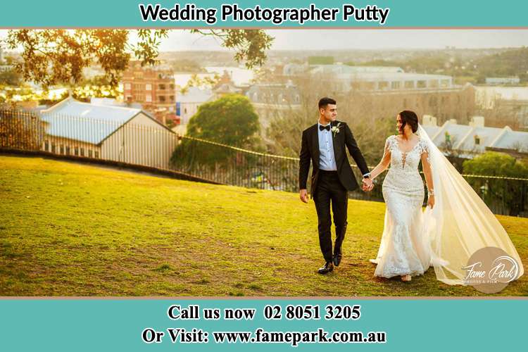 Photo of the Groom and the Bride holding hands while walking Putty NSW 2330