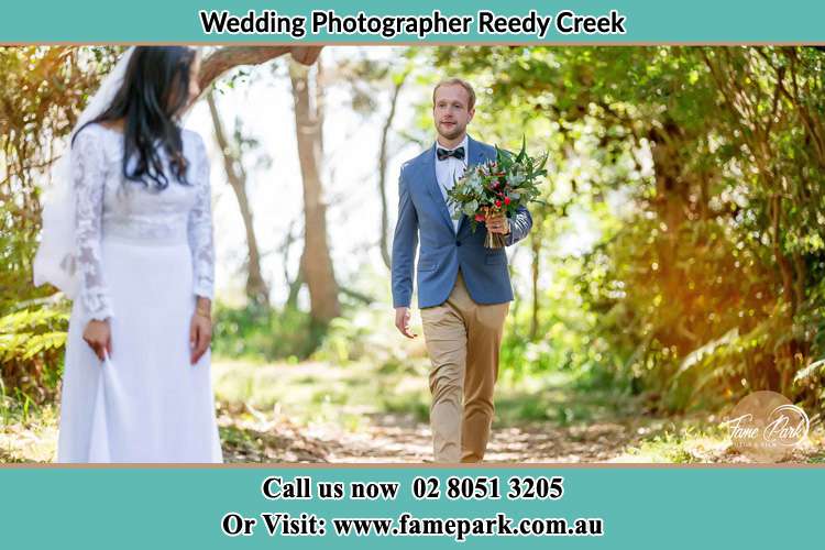 Photo of the Groom bringing flower to the Bride Reedy Creek NSW 2330