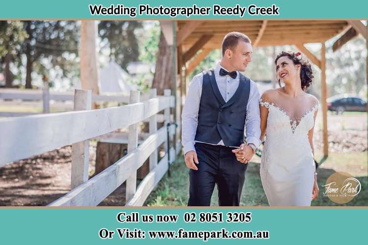 Photo of the Groom and the Bride holding hands while walking Reedy Creek NSW 2330