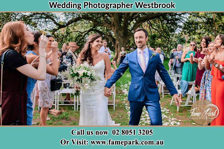 Photo of the Bride and the Groom showering bubbles by the visitors Westbrook NSW 2330